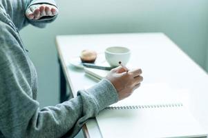 Writing on paper at work on the table in the morning, business ideas. There is space for copying. photo