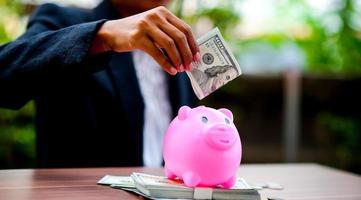 Close-up pictures of money and pigs, saving money Saving money The concept of saving money photo