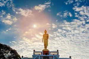 Standing Buddha image And the blue sky, religious concepts photo