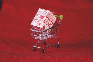 Red background and shopping trolley Shopping concept and trading photo