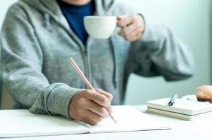 escribiendo en papel en el trabajo sobre la mesa por la mañana, ideas de negocios. hay espacio para copiar. foto