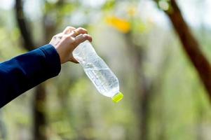 Hand and water bottle Drinking water Creative concept With copy space photo