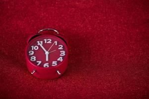 Red background image and beautiful red alarm clock Concept, time, date photo