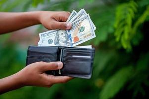 Dollar hand and purse images Concept of business finance photo