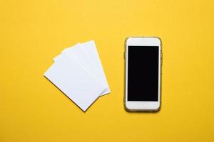 Phones, communication devices placed on a yellow background Technology concept With copy space photo