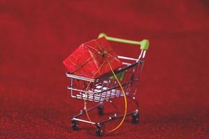 Red background and shopping trolley Shopping concept and trading photo