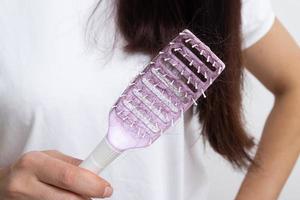 Comb with lost female hair. Tangled and falling out hair, care for long hair photo