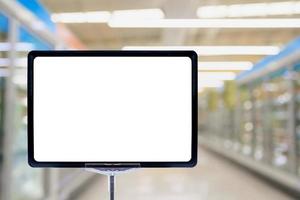 Blank price board over frozen product aisle in supermarket photo