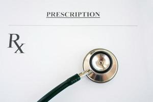 Prescription form lying on table with stethoscope photo