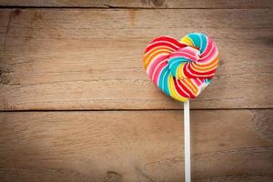 colorful heart lollipop on wood background photo