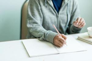 Writing on paper at work on the table in the morning, business ideas. There is space for copying. photo
