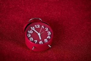 Red background image and beautiful red alarm clock Concept, time, date photo