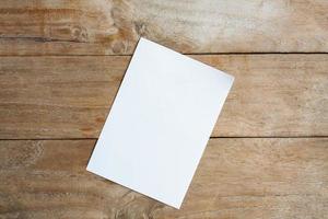 Blank paper on wood table photo