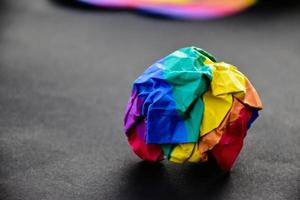 Rainbow colored paper cubes on black and blur background, concept for lgbt celebrations in pride month, June, around the world, soft and selective focus. photo