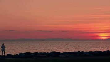 Lonely Woman At Red Beach Sunset video