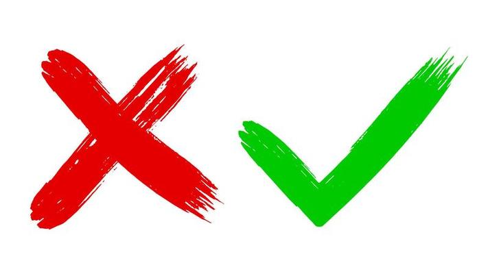 Two dirty grunge hand drawn with brush strokes cross x and tick OK check marks