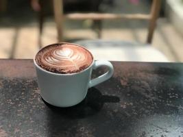 Hot coffee cup on wooden table photo