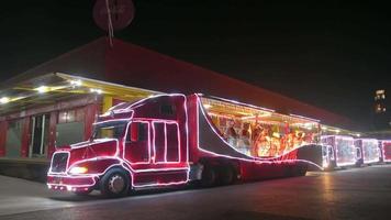 Tbilisi, Georgia, 2021 - static view traditional red coca cola xmas open roof festive truck with white teddy bears inside. Christmas festive celebrations and festive vehicle on road video
