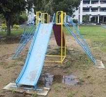 Colorful playground for childrens focus on slider.with wet ground. photo