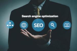 Hand businessman icon SEO Search engine optimization  virtual screen.Social network digital business concept. photo