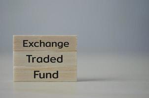 wooden cube block icon ETF Exchange Traded Fund on table.Business stock market finance Index Fund Concept. photo