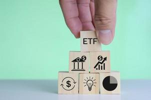 wooden cube block icon ETF Exchange Traded Fund on table.Business stock market finance Index Fund Concept. photo