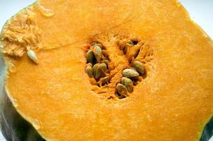 piece of cut yellow pumpkin with grains photo