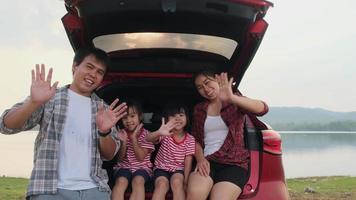 Happy family enjoying road trip on summer vacation. The family travels on the road in their favorite car. Holiday and travel family concept.