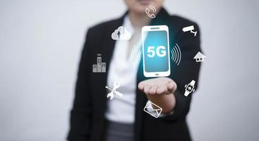 Business hold mobile phone with technology 5G of mobile telecommunication network in Europe for high speed wireless data connection to internet from smartphones, future technology 5G network. photo