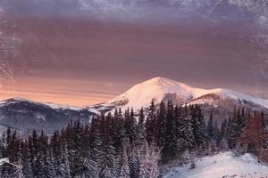 Magic sunset in the snowy mountains. Vintage effect photo