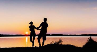 couple on the bike at sunset photo