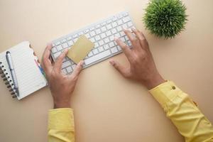 man hands holding credit card and using laptop shopping online photo