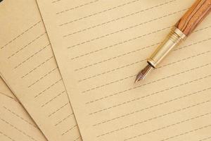 old empty paper and fountain pen on table photo