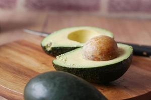 slice of avocado on wooden table photo