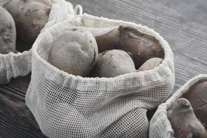 Close up of raw potato in a shopping bag photo