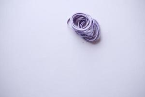 purple color Rubber bands on table photo