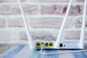 Wi-Fi router with cables on table photo