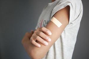 adhesive bandage on young man's arm photo