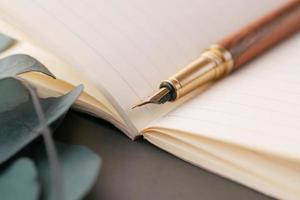 old empty paper and fountain pen on table photo