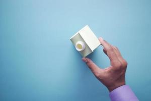 men hand holding a milk container on light green background photo