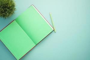 high angle view of open notepad on light color background photo