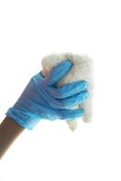 close up of person hand in gloves cleaning window glass photo