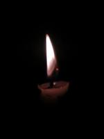 Close up of lighting candles in darkness photo