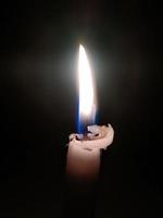 Close up of lighting candles in darkness photo