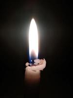 Close up of lighting candles in darkness photo