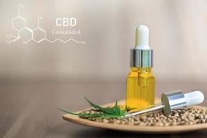 CBD composition in cannabis, cannabis oil in glass bottle, organic cannabis oil, alternative herbal medicine concept. Organic herbs. Scientific cannabis symbol. photo