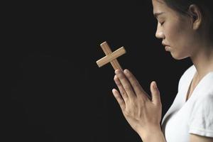 girl praying to god Both hands clasped the cross. Ideas for Christ. Christianity. Catholic religion. sacred. Heaven. Pray. Believe. Faith. Pray. Desire. photo