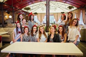 Fantastic girls enjoying bachelorette party at the table in the restaurant. photo