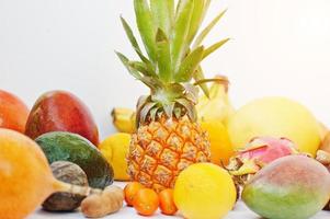 Exotic fruits isolated on white background. Healthy eating dieting food. Pitahaya, carambola, papaya, baby pineapple, mango, passion fruit, tamarind and other. photo