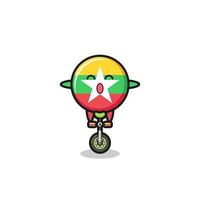 el lindo personaje de la bandera de myanmar está montando una bicicleta de circo vector